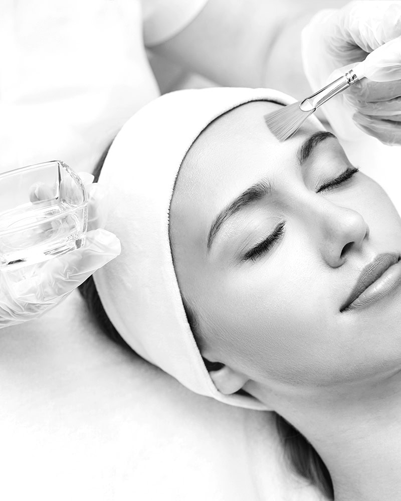 A woman with a headband receives a relaxing facial from a gloved professional at a Medical Spa Nassau County.